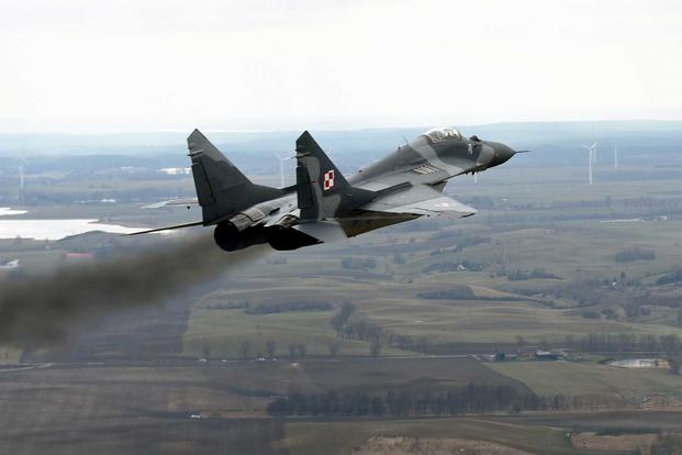 A Polish Air Force MiG-29 fighter accelerates and climbs.