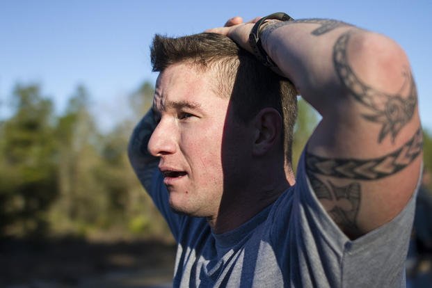 An Army reservist catches his breath after finishing the two-mile run portion of the Army physical fitness test.