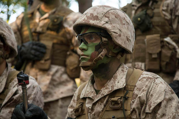 A U.S. Marine Corps officer candidate attending Officer Candidate School (OCS) listens during a brief before conducting a field training exercise.