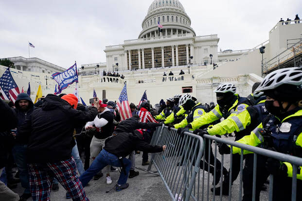Trump supporters try to break through a police barrier at the U.S. Capitol.