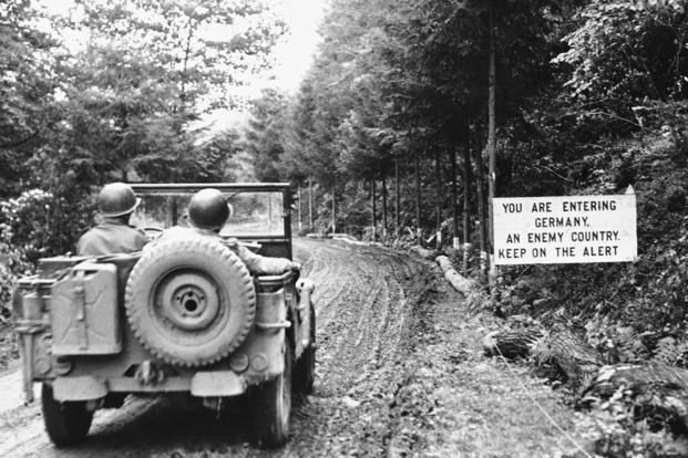 Sign attracts attention of jeep occupants as they move into Germany from Belgium.