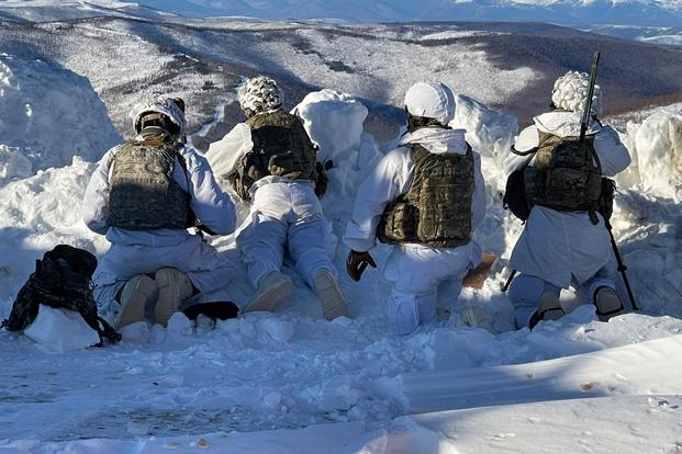 Snipers provide cover for infantry during a training exercise in Alaska.