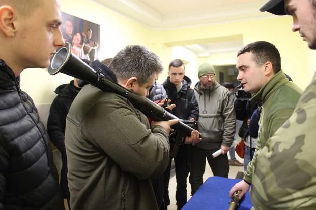 A volunteer fighter holds a bazooka in Lviv, Ukraine.