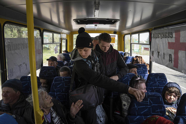 People ride in the bus during evacuation near Lyman, Ukraine.