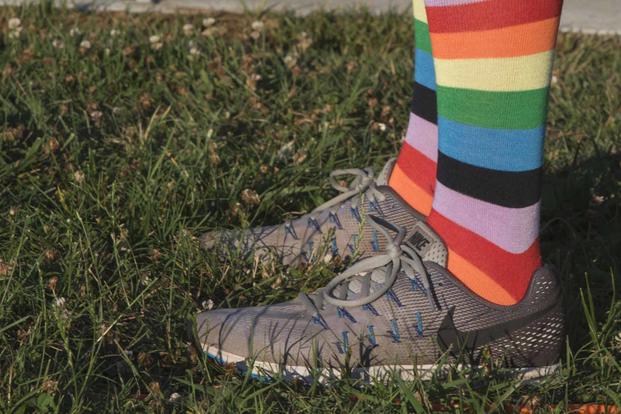 A base member wears rainbow socks during an LGBT Pride Month event.