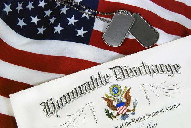 Honorable discharge certificate with dogtags and American flag
