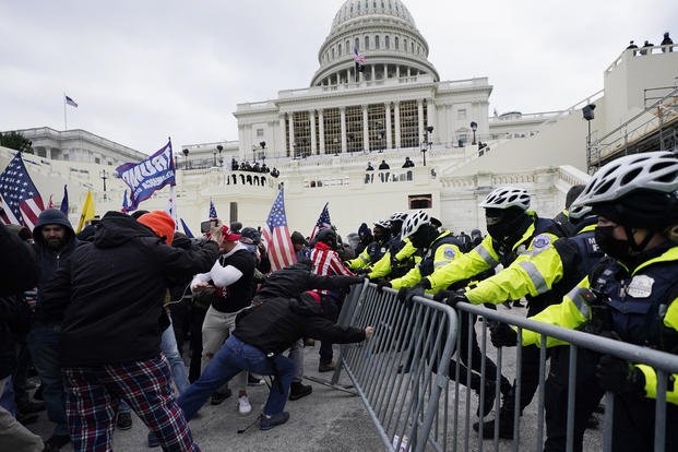 Insurrections break through a police barrier at the Capitol in Washington.