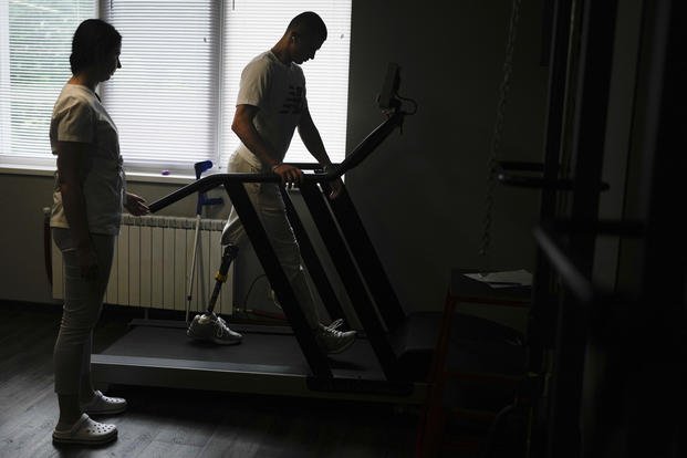 "Buffalo," the name he uses as a soldier, walks on a treadmill at a clinic in Kyiv