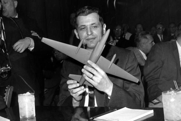 U-2 spy plane pilot Francis Gary Powers holds a U-2 model plane as he sits before the Senate Armed Services Committee in Washington, D.C.