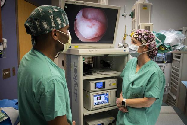 Two Army doctors review a hysteroscopy at Brooke Army Medical Center.