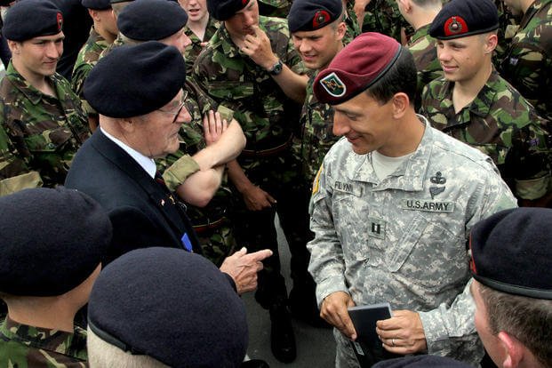 A captain gets a few pointers from a retired member of the Royal Marines during a D-Day remembrance.