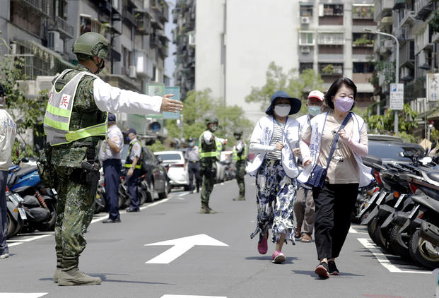 People are guided by Taiwan's soldiers during the Wanan air raid drill in Taipei, Taiwan