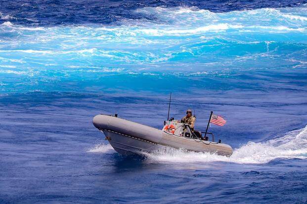 A U.S. Navy sailor in a boat off the coast of Somalia.