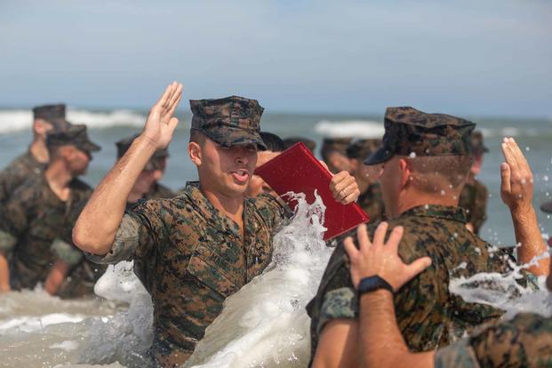 Cpl. Courtland Mabe, reenlists in the ocean.