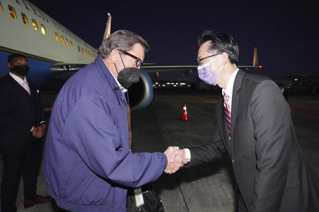 U.S. Democratic House member John Garamendi shakes hands with Donald Yu-Tien Hsu.