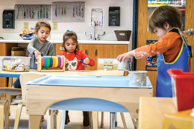 Children in the Strong Beginnings program play in the art area at the Ivy Child Development Center at Fort Carson, Colorado.