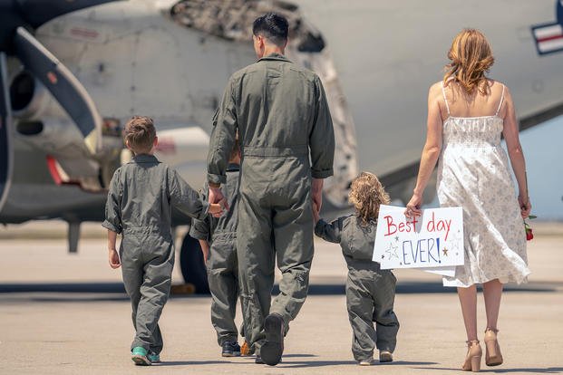 Lt. Cmdr. Carlos Molina walks with his family following a seven-month deployment aboard the USS Abraham Lincoln. 