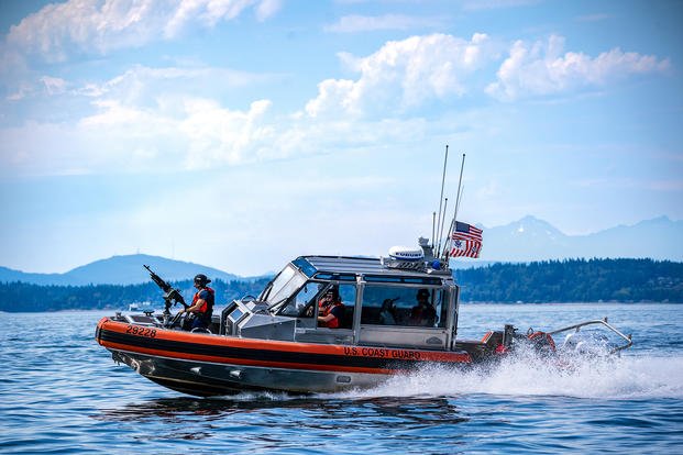 A Coast Guard boat crew patrols Puget Sound in Seattle during the military’s annual Fleet Week celebration. 