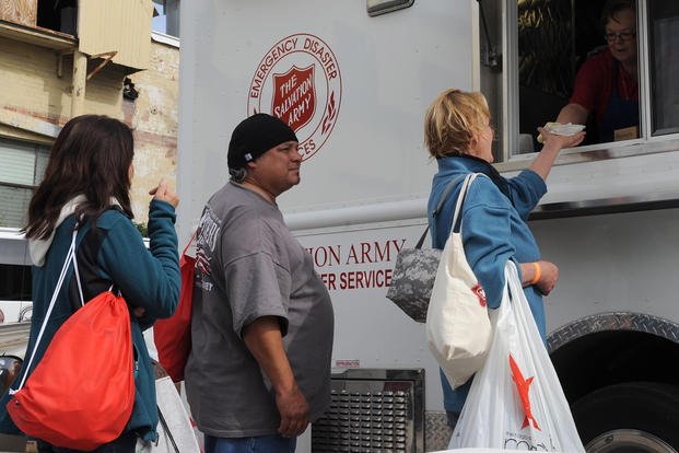 Volunteers with the Salvation Army utilize an emergency disaster food truck to provide hot food to homeless veterans during the Veterans Stand Down sponsored by the American GI Forum National Veterans Outreach Program.