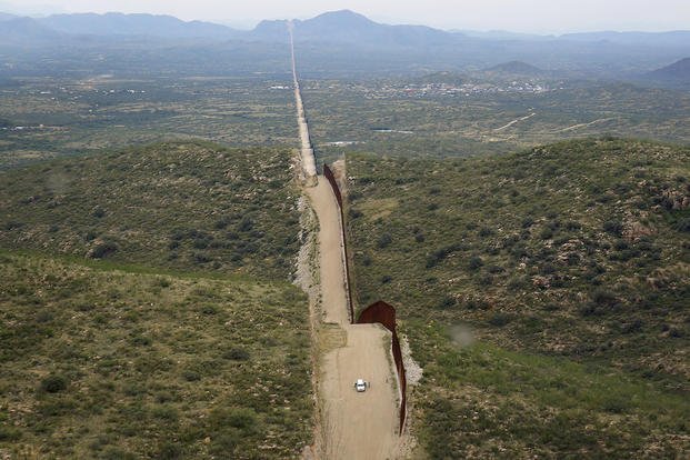 The wall along the border between the United States and Mexico.