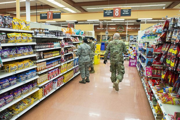 Airmen from around Wright-Patterson Air Force Base, Ohio, help stock shelves inside the base commissary.