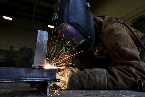 Staff Sgt. Tyler Hester welds a metal sign together at Kunsan Air Base.