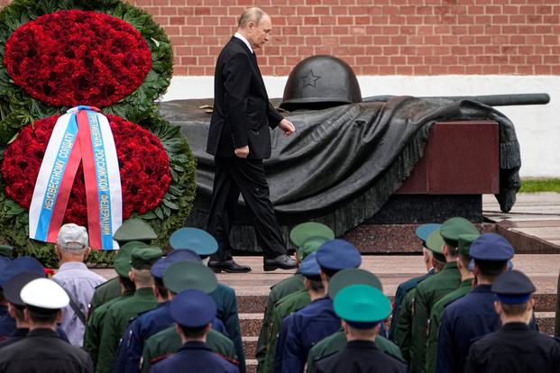 Russian President Vladimir Putin attends a wreath-laying ceremony.