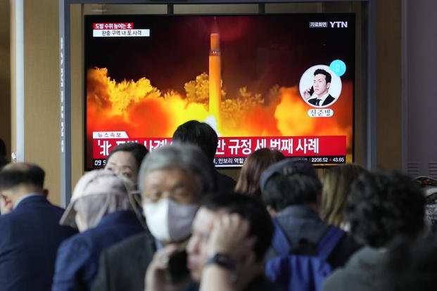 TV screen shows a file image of North Korea's missile launch at the Seoul Railway Station