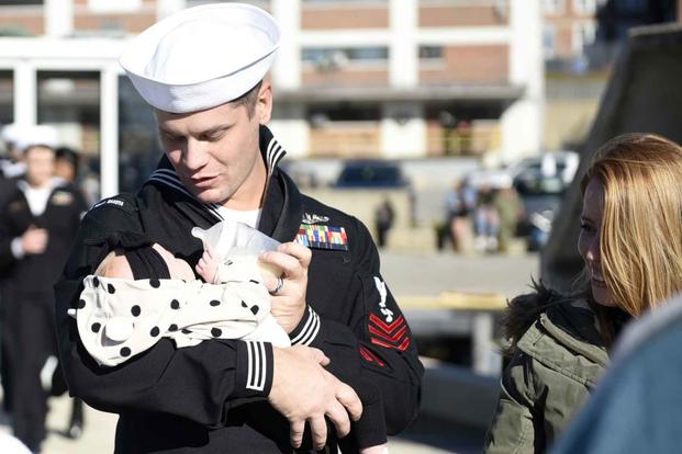 A sailor returns home from deployment aboard the USS North Dakota.