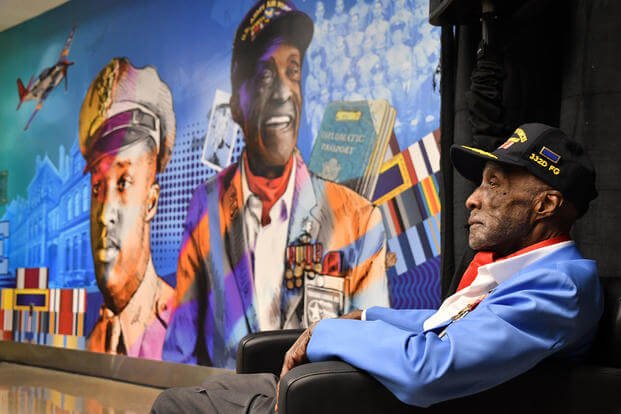 Tuskegee Airman Enoch O’Dell “Woody” Woodhouse II with the mural honoring him