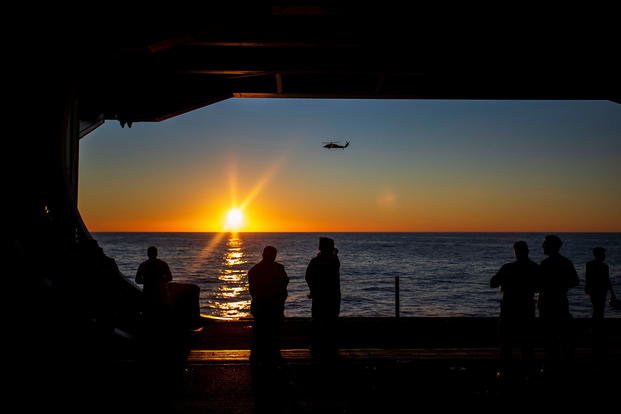 helicopter flies past the USS Gerald R. Ford CVN-78 in the Atlantic Ocean