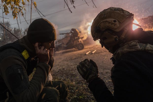 Ukrainian servicemen fire toward Russian positions in the frontline near Kherson, Ukraine.