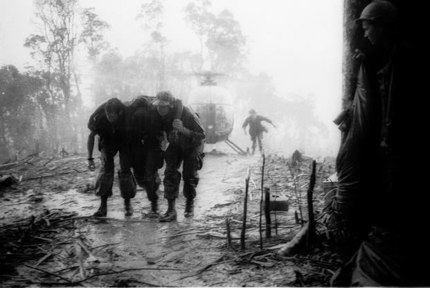 Medics assist a wounded soldier from the 101st Airborne Division in Vietnam.