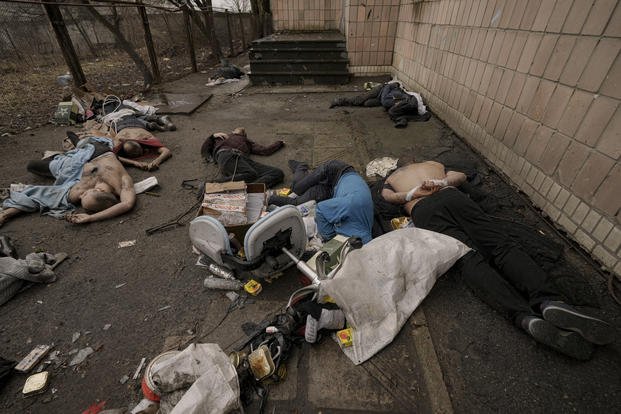 Lifeless bodies of men lie on the ground in Bucha, Ukraine.