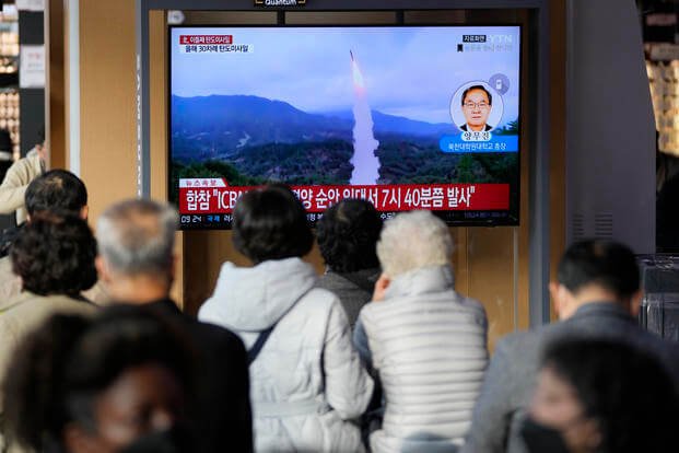 TV screen showing a news program reporting about North Korea's missile launch with file footage