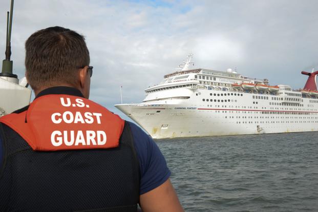 Cruise ship approaching a Coast Guard member in the water near Jacksonville, Florida.