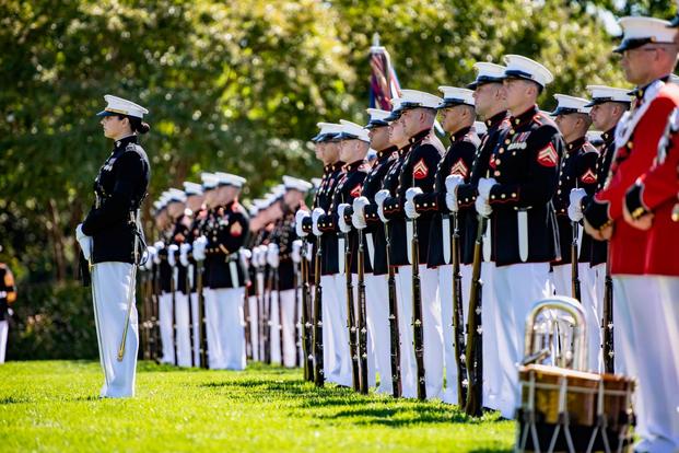 A platoon of Marines conduct military funeral honors at Arlington National Cemetery.