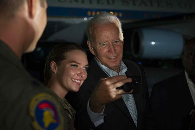 President Joe Biden takes selfie with an airman at Anderson Air Force Base.