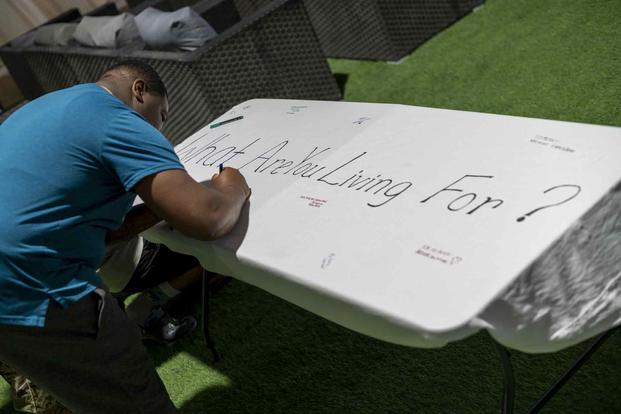 Airman writes message during a Suicide Prevention Month event.