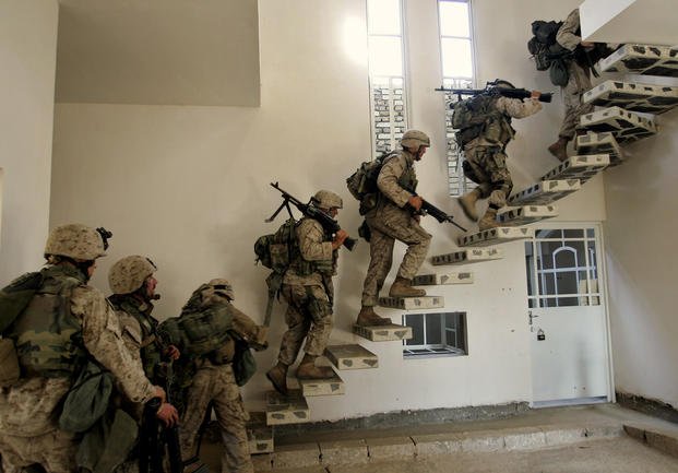 US Marines of the 1st division enter a house in Fallujah, Iraq, in 2004.