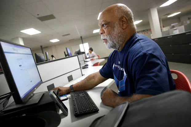 Air Force veteran Thom Brownell uses a computer to search for a job at the Texas Workforce Solutions office in Dallas.