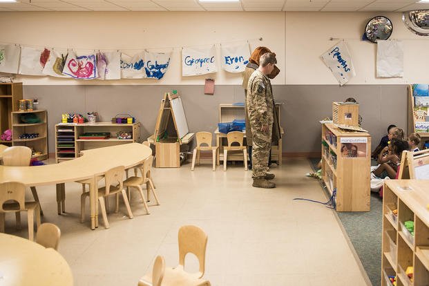McGruff the Crime Dog and Staff Sgt. Daniel D'Acierno, 27th Special Operations Security Forces Squadron NCO-in-charge of police services, visit children at the Chavez Child Development Center at Cannon Air Force Base, N.M.