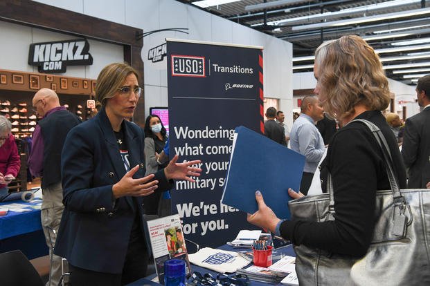 Carmen Perez, the Wiesbaden United Service Organizations center manager, talks about the USO with a community member at the Army Community Service job fair on Hainerberg, Wiesbaden, Hessen, DE.