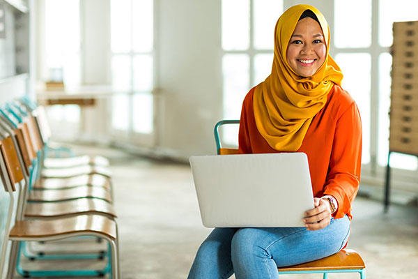 woman holding laptop