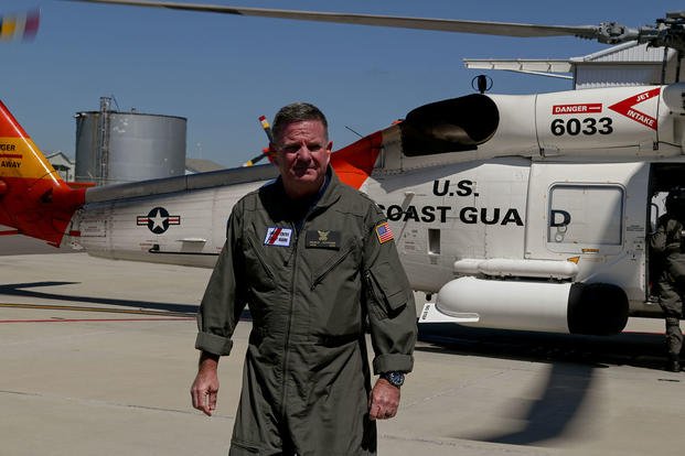 Rear Adm. Brendan Mcpherson disembarks a Coast Guard Air Station Clearwater MH-60 Jayhawk