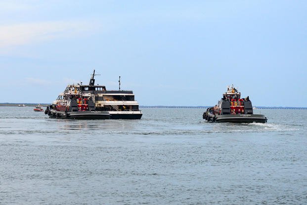 The Spirit of Norfolk is in tow and meeting the Coast Guard Station Portsmouth 45-foot response boat crew