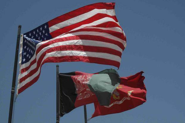 American, Afghan, and U.S. Marine Corps flags.