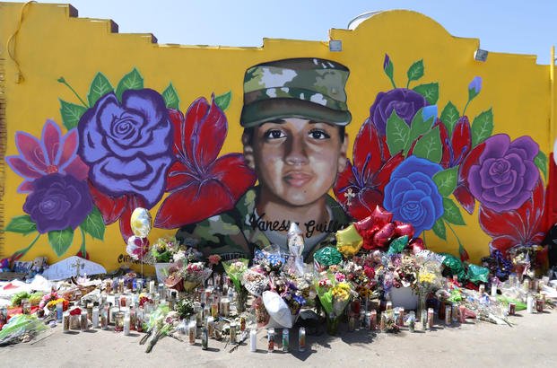 Offerings sit in front of a mural of slain Army Spc. Vanessa Guillen .