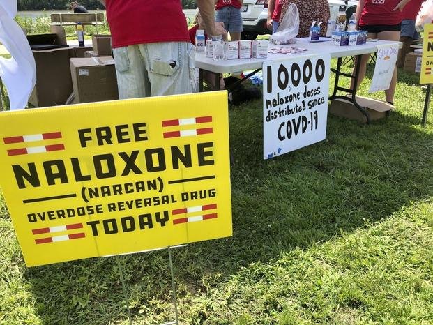 Signs are displayed at a tent during a health event