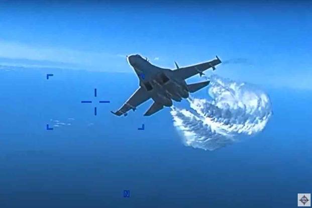 Two Russian Su-27 aircraft intercept a U.S. Air Force drone over the Black Sea.
